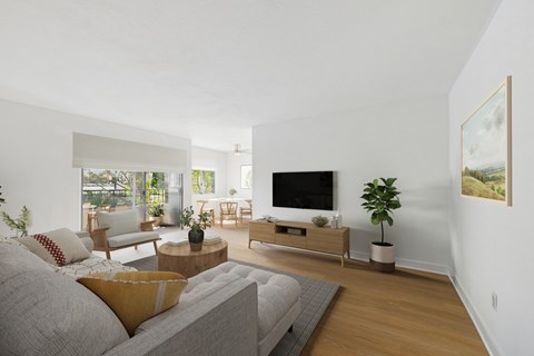 A living room with a grey couch and a wooden coffee table.