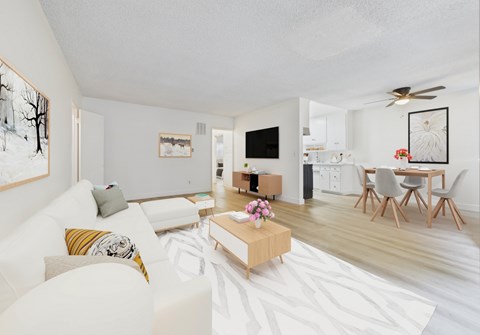 A living room with a white couch and a coffee table.