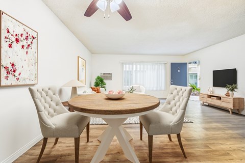 A dining room with a round table and chairs.