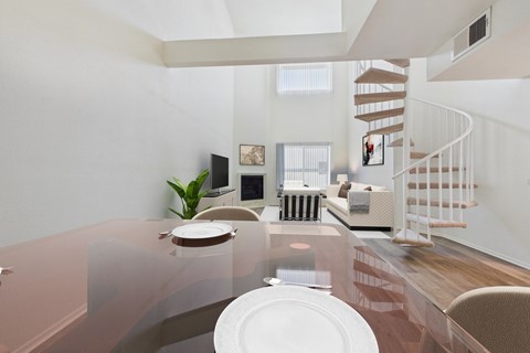 A modern dining room with a glass table and chairs.