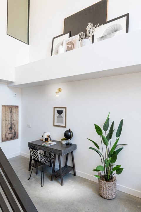 A dining room with a table and chairs.