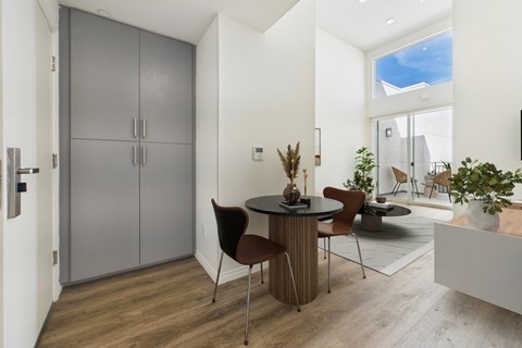 A modern dining room with a table set for two.