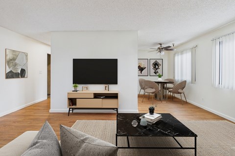 A living room with a black coffee table and grey couch.