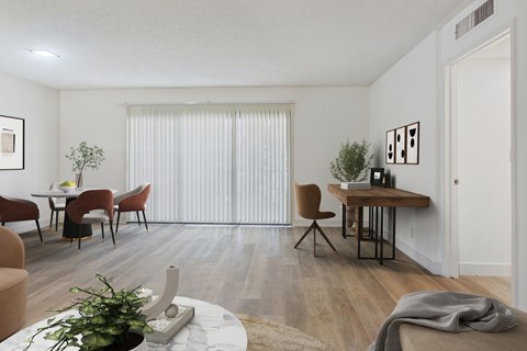 A living room with a dining table and chairs.