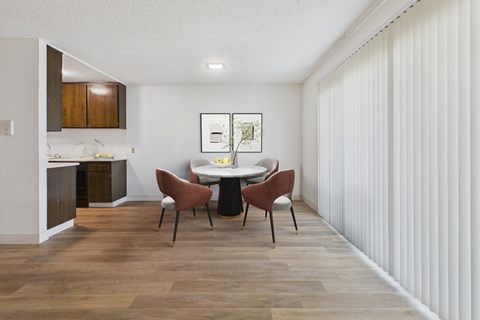 A dining room with a table and chairs.