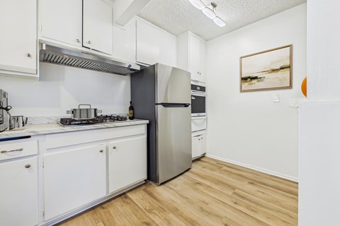 A kitchen with a stove, oven, and refrigerator.