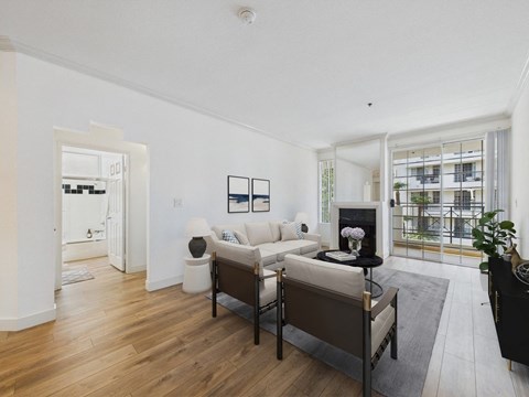 A living room with a white couch and a black chair.
