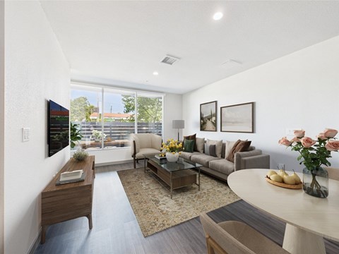 A living room with a grey couch and a coffee table.