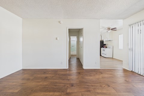 A room with wooden floors and white walls.