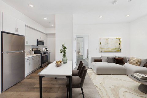 A modern kitchen with a dining table and chairs.
