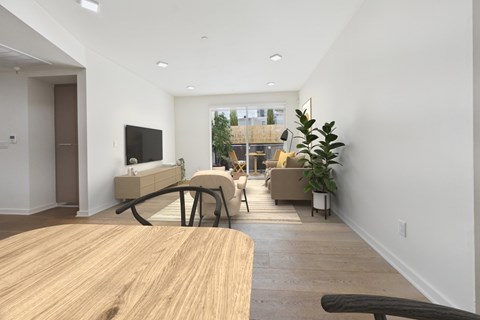 A modern living room with a wooden table and a flat screen TV.
