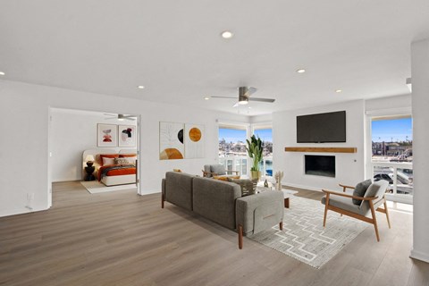 A living room with a grey couch and a television.