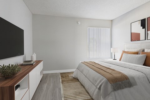 A bedroom with a large bed and a television on the wall.