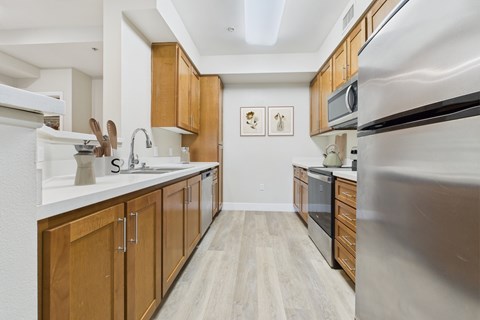 A kitchen with wooden cabinets and stainless steel appliances.
