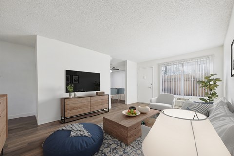 A modern living room with a flat screen TV, a sofa, a coffee table, and a bean bag chair.