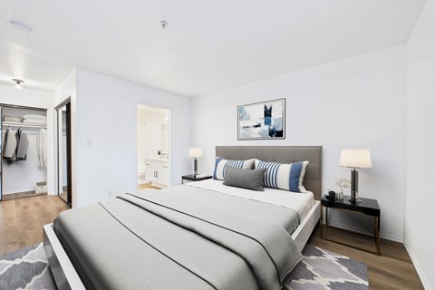 A bedroom with a large bed and a painting on the wall.