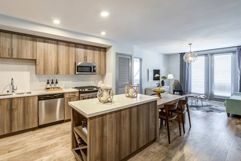 A modern kitchen with wooden cabinets and a central island.