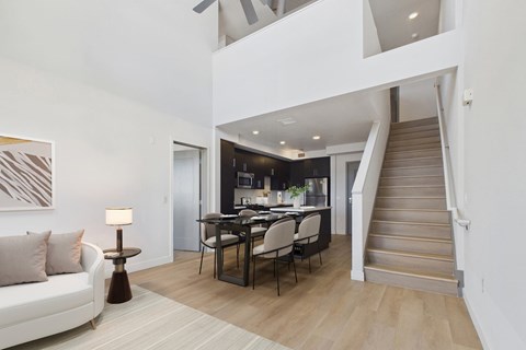 A modern living room with a staircase leading to the upper floor.