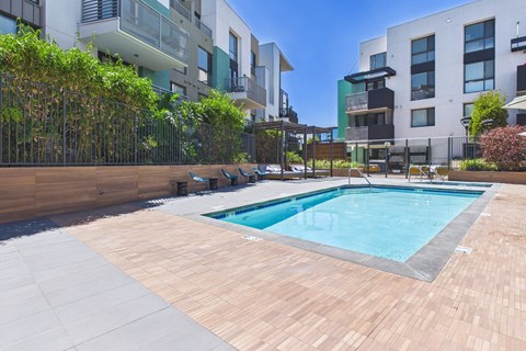 A small pool surrounded by a wooden deck.