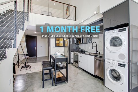 A modern kitchen with a washing machine and a dining table.