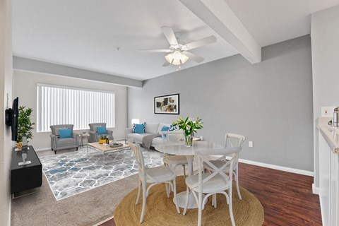 A living room with a dining table and chairs.