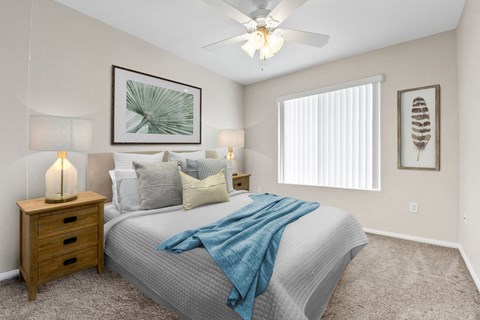 a bedroom with a large bed and a ceiling fan