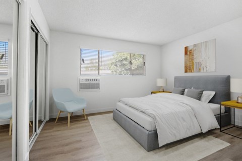a bedroom with a bed and a chair and a sliding glass door