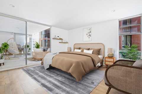 a bedroom with a bed and a sliding glass door