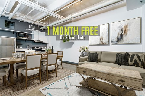 A modern kitchen and dining area with a sign offering 1 month free on select units.