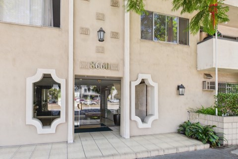 The image shows a building with a beige facade and a sign that reads "1860".