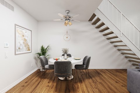 a dining room with a table and chairs and a ceiling fan