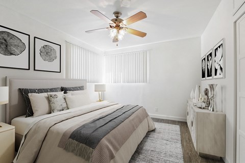 a bedroom with a large bed and a ceiling fan