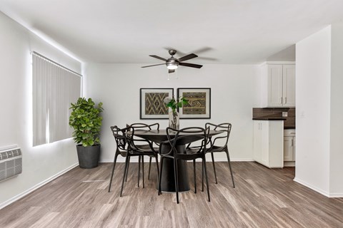 A dining room with a table set for six.