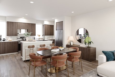 A modern kitchen with a dining table set for six.