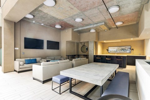 A modern living room with a large couch and a television.
