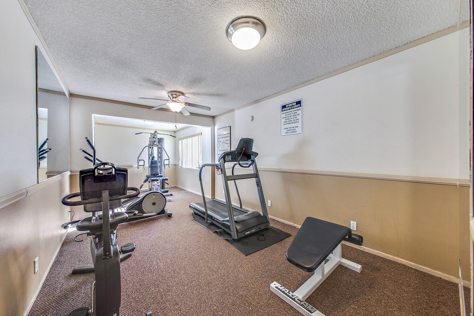 Fitness center including treadmill, stationary bike, Sit-up bench and pec deck machine