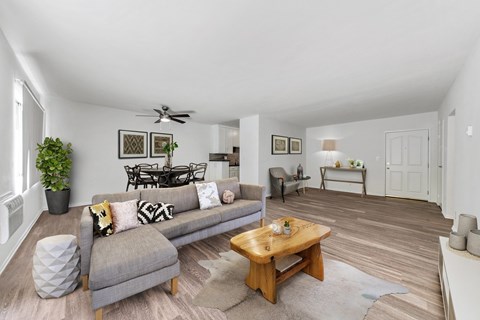 A living room with a grey couch and a wooden coffee table.