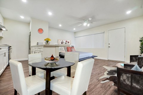 A dining room with a table and chairs.