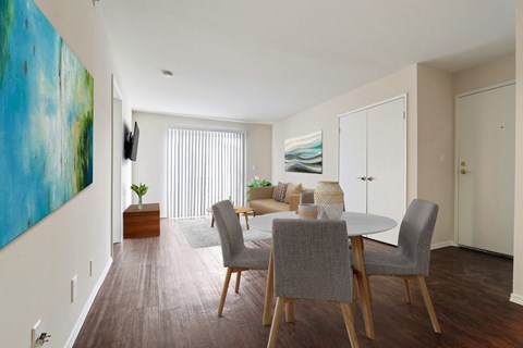 A dining room with a grey table and chairs.