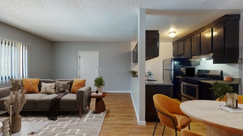 A living room with a grey couch and a brown chair.