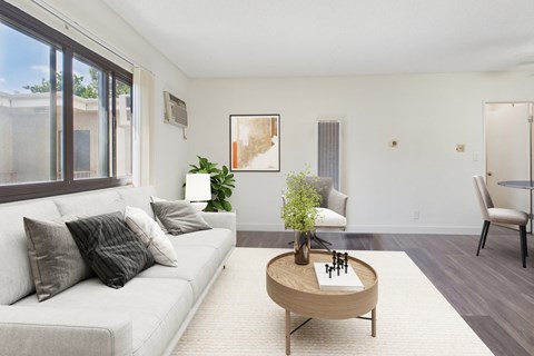 A living room with a white couch and a coffee table.