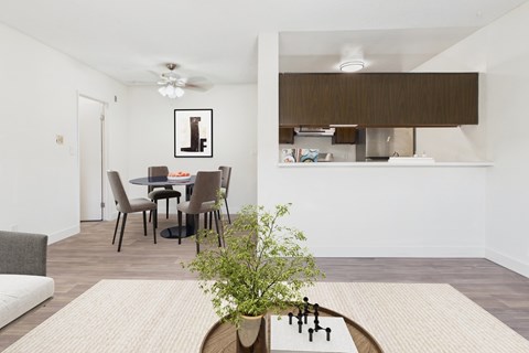 A dining room with a table and chairs.