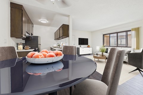 A modern kitchen with a table and chairs.