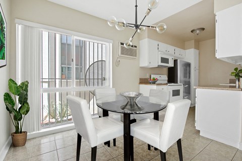 A dining room with a table and chairs.