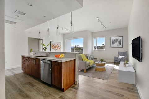 A modern kitchen with wooden cabinets and a large island.