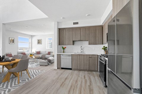 A modern kitchen with a dining table and chairs.