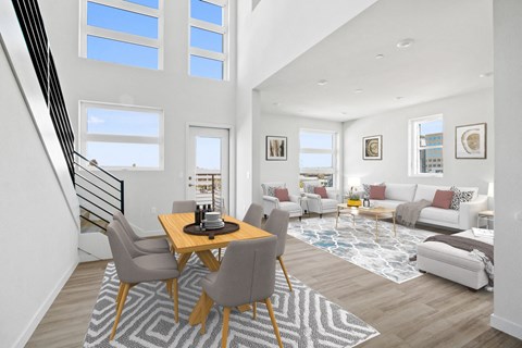A modern living room with a dining table and chairs.