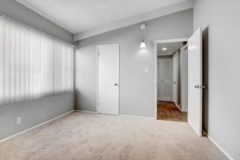 A room with a carpeted floor and white walls.