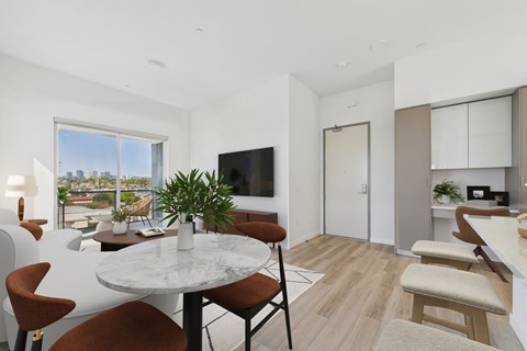 A modern dining room with a table set for four.