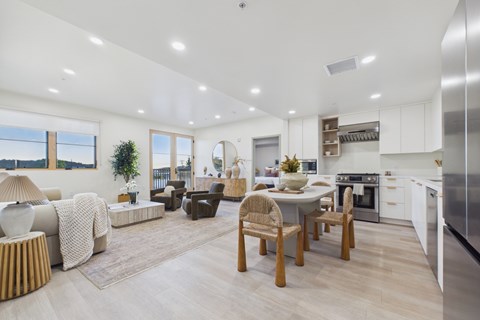 A modern kitchen with a dining table and chairs.